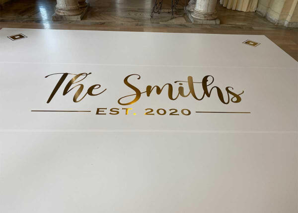 "The Smiths - EST. 2020" custom floor graphics at wedding reception