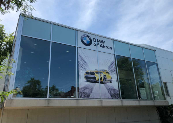 Custom window advertising decals for BMW dealership in Akron, Ohio