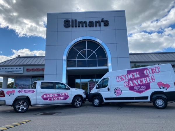 Breast Cancer Awareness Signage on the side of a van and a truck made by Oliver Signs & Advertising.