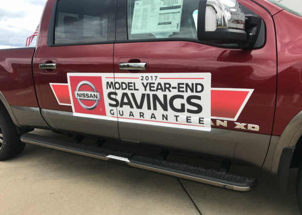 Graphic on side of car showing a clearance sale for a business. Get clearance signs at Oliver Signs & Advertising.