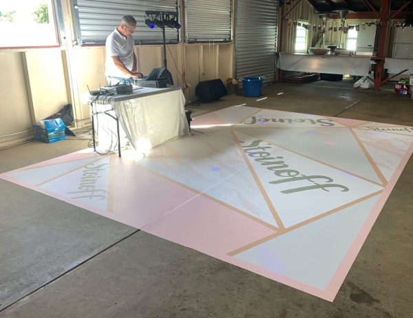 Custom floor graphics on wedding reception dance floor