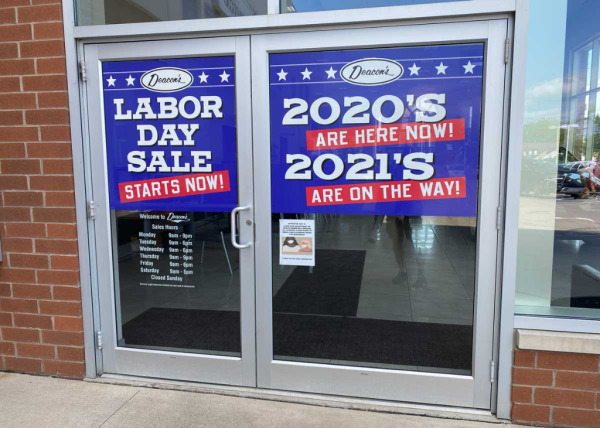 "Labor Day Sale" door ad band decals at Deacon's auto dealership in Mayfield, OH