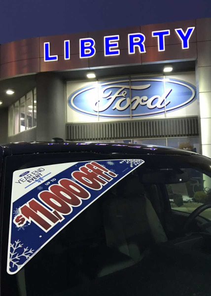 Window triangle decal advertises year end sale at a Ford dealership