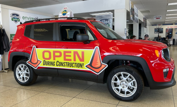"Open During Construction" magnetic vehicle sign at Spitzer dealership