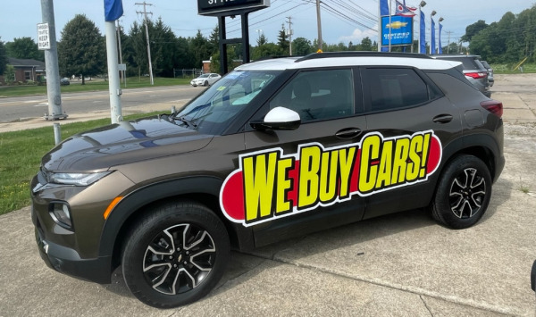 "We Buy Cars!" magnetic vehicle sign at Chevrolet dealership