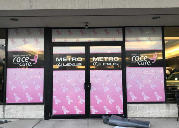 Custom window decals & glass door decals advertising Race for the Cure event at Metro Lexus dealership