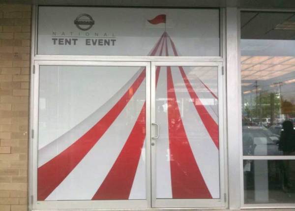 Custom window decal & glass door decals advertising National Tent Event at Nissan dealership
