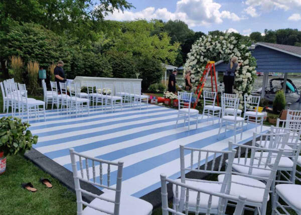 Blue and white striped floor graphics on outdoor dance floor platform