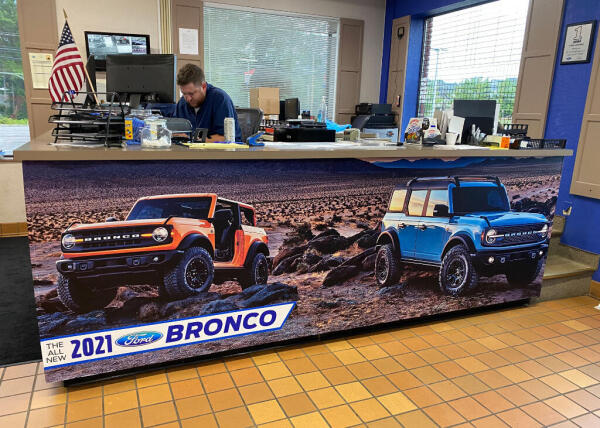 A custom order for front counter graphics featuring two broncos.